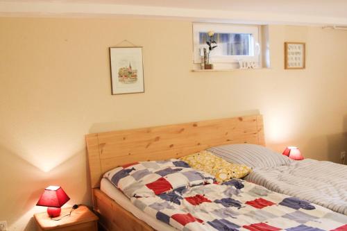 a bedroom with a bed with a quilt on it at FeWo Seelücke in Munkbrarup