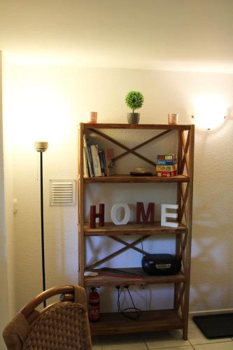 a book shelf with the word home written on it at FeWo Seelücke in Munkbrarup