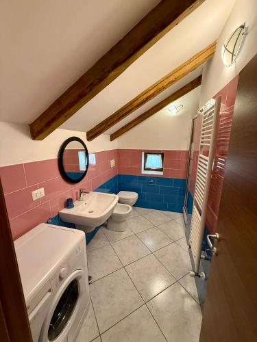 a bathroom with a sink and a washing machine at Villa Monti in Courmayeur