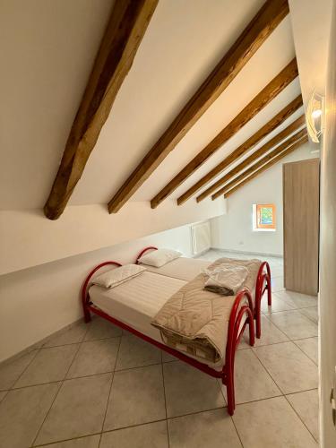a bedroom with a bed in a room with wooden ceilings at Villa Monti in Courmayeur