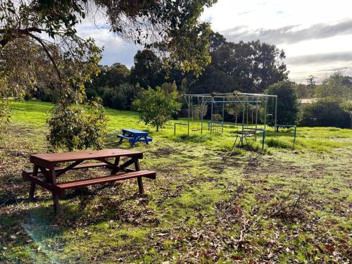 a park with a picnic table and a goal at Woodbridge Vista - Heated Pool in Yallingup in Yallingup Siding