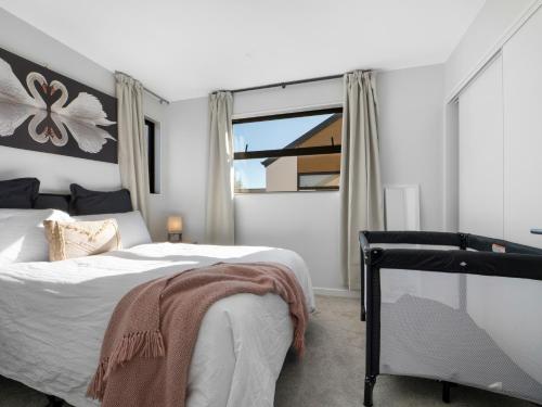 a bedroom with a bed and a large window at Apartment on Short ! in Christchurch