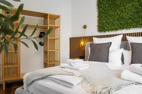 a bedroom with a bed with towels on it at Penthouse Apartment - 10 min to Cologne & Parking in Hürth