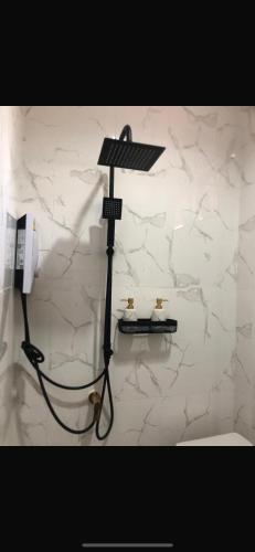 a light on a wall in a bathroom with a phone at Bungalow Coco in Amphoe Koh Samui