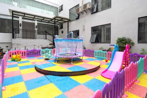 a playground in a building with a colorful carpet at GUI YUAN ZHEN PIN HOTEL- Approximately 3 kilometers from the East Gate of Zhangjiajie National Forest Park - Free one-way pick-up or drop-off service for over 3 nights - English speaking customer service in Zhangjiajie