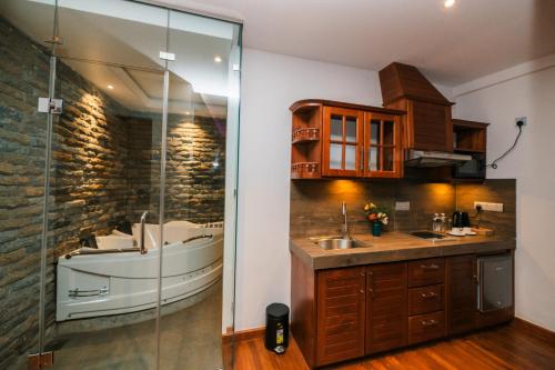 a bathroom with a sink and a glass shower at Baron Luxury Boutique in Nuwara Eliya