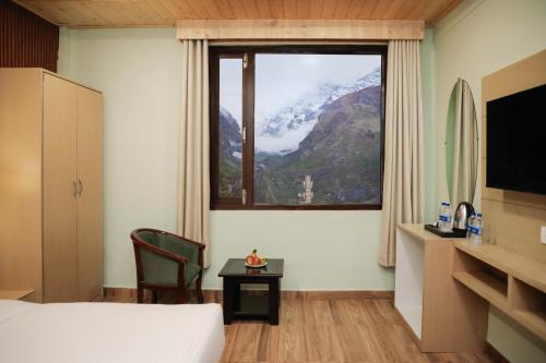 a hotel room with a view of a mountain at ECKO Premier New Yoga in Badrīnāth