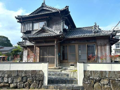 an asian style house with a stone wall at Matsu no Yama, center of Goto, rent the whole house, maximum 7 people in Goto