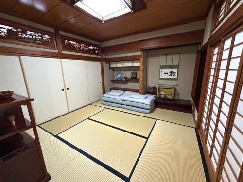 a room with a bed in a room with windows at Matsu no Yama, center of Goto, rent the whole house, maximum 7 people in Goto