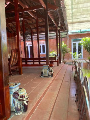 an empty patio with benches and tables in a building at Sweet Home in Tân Phú