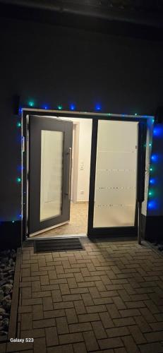 an open door of a building with blue lights at Natur pur in Netphen