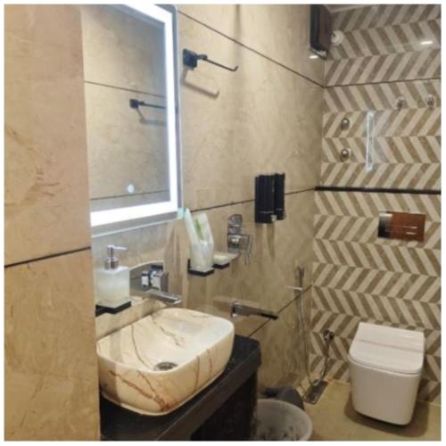 a bathroom with a sink and a toilet at The House Hotel Darjeeling in Darjeeling