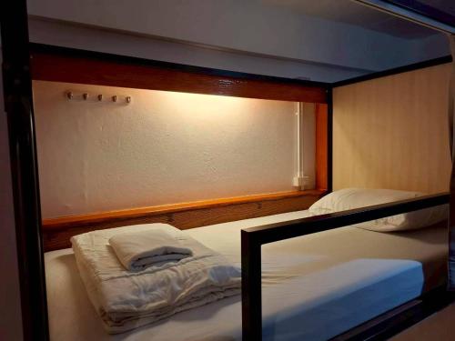 a couple of bunk beds in a room at Before We Go Hostel Donmueang in Ban Ko