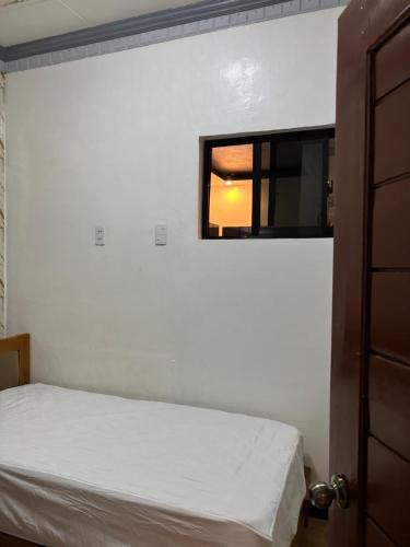 a bedroom with a bed and a window at Spacious Home with Great Location in Panabo City in Panabo