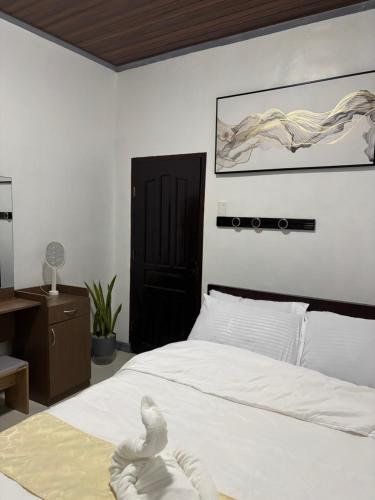 a bedroom with a bed with a swan on it at Spacious Home with Great Location in Panabo City in Panabo