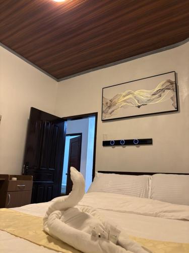 a bedroom with a bed with a swan on it at Spacious Home with Great Location in Panabo City in Panabo