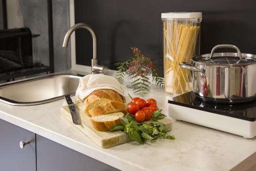 a loaf of bread sitting on a counter next to a sink at Donna Lucia by Armerina Sicily Apartments in Piazza Armerina