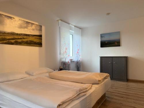 a bedroom with two beds and a painting on the wall at Ferienhaus Winterberg in Winterberg