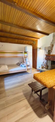 a bedroom with a bed and a bench in a room at Casa nei boschi della Val Bormida in Calizzano