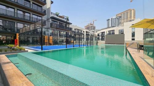 a swimming pool in the middle of a building at Free housekeeping visits during your stay - StayShort - Modern 2 Bed Sleeps 3 in JVC with City Views in Dubai