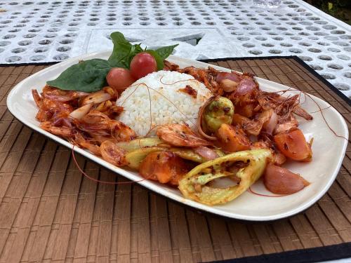 a plate of food with shrimp and other foods on a table at Headman House Antique Villa - Ahangama in Ahangama