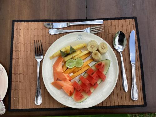 a plate of fruit and vegetables on a table at Headman House Antique Villa - Ahangama in Ahangama