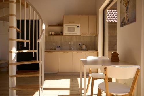 a kitchen with a table and chairs and a staircase at Osada Iwiec-Karpaty 