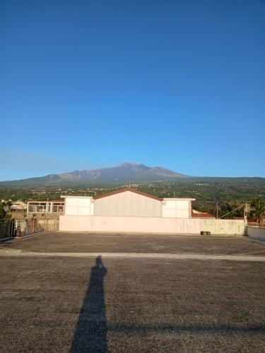 a shadow of a person standing in a parking lot at Acqua di Mare in Mascali