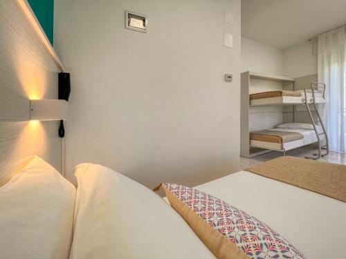 a bedroom with a bed and a bunk bed at Ambra Hotel Cattolica in Cattolica