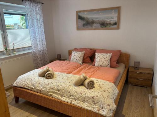 a bedroom with a bed with two pillows on it at Ferienwohnungen am Grannenhof in Einbeck