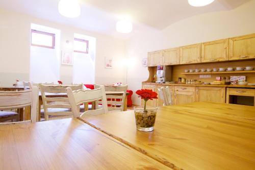 a kitchen with a table with a vase with a flower on it at Wellness Apartment De Luxe in Liberec