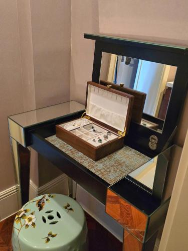 a table with a box on top of it at Jin Jiang Hotel Shanghai - historical hotel in the city-center of Huaihai shopping area and convenient access to metro lines in Shanghai