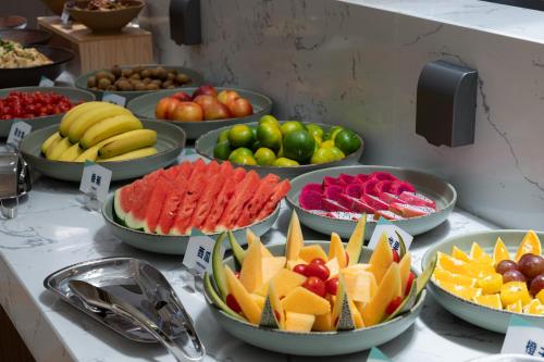 a buffet filled with different types of fruits and vegetables at Atour Hotel Foshan Chancheng Zhangcha in Foshan