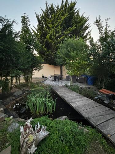 a garden with a wooden walkway and a pond at Ferienwohnung in Bad Rappenau in Bad Rappenau