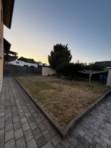 a backyard with a grassy yard with a sidewalk at Ferienwohnung in Bad Rappenau in Bad Rappenau