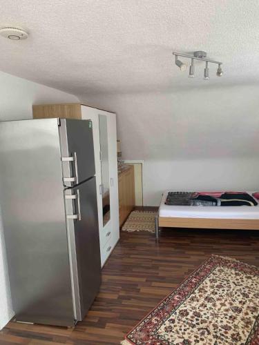 a room with a refrigerator and a bed in it at Ferienwohnung in Bad Rappenau in Bad Rappenau
