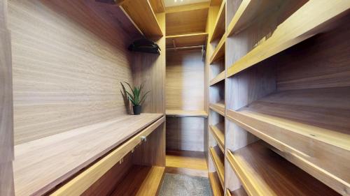 a walk in closet with wood paneling and a plant at Panorama Penthouse in Ashford