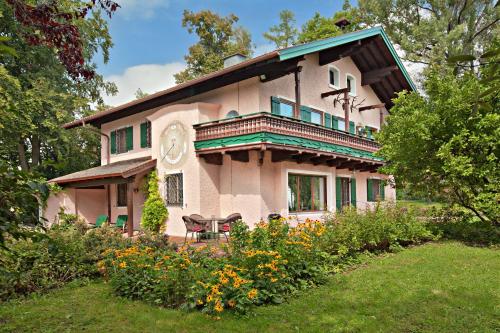 a large house with a balcony on top of it at Landhaus Ruperti in Waging am See
