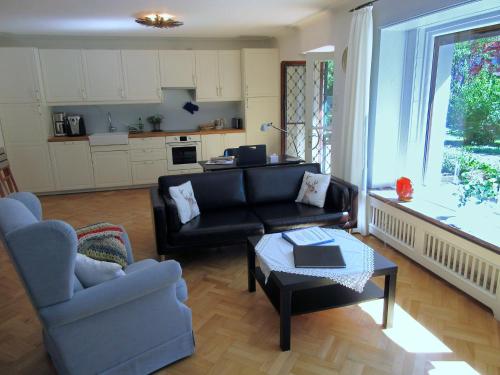 a living room with a couch and a table at Landhaus Ruperti in Waging am See