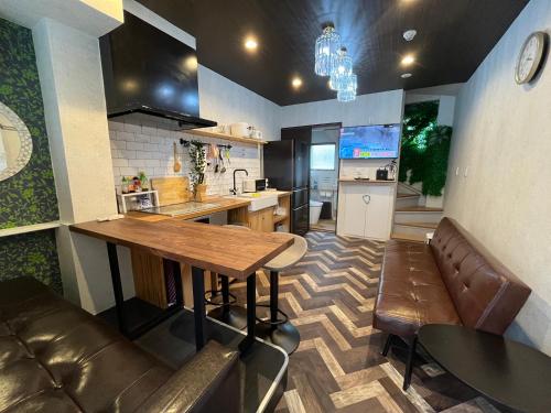 a kitchen with a wooden table and a counter top at 池袋C1出口徒歩5分　2LDK まるまる貸切　衛生設備充実 in Tokyo