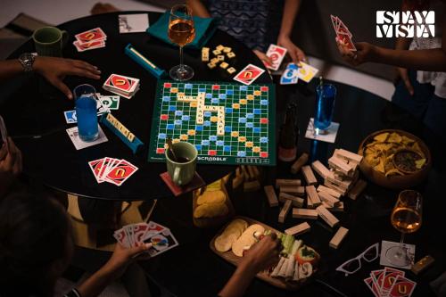 a group of people playing a board game on a table at StayVista at Casa Canto with Infinity Pool in Siolim