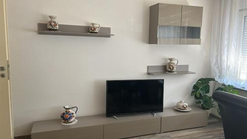 a living room with a flat screen tv on a cabinet at Ferienwohnung in Bad Rappenau in Bad Rappenau