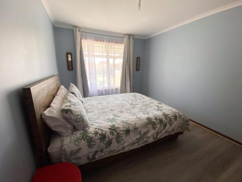 a bedroom with a bed and a window at Sea Breeze in Lancelin