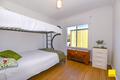 a bedroom with a bunk bed and a window at Sea Gem in Lancelin