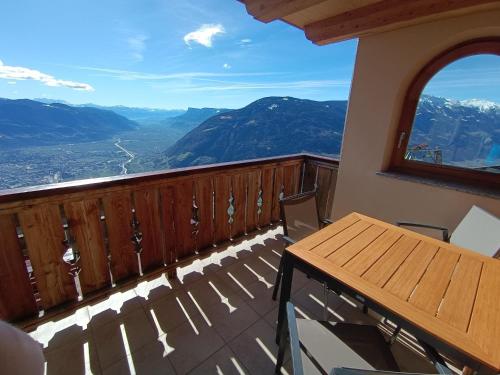 a balcony with a table and chairs and mountains at Oberplatzer in Foresta