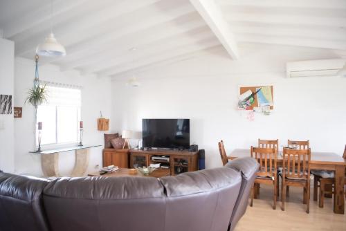 a living room with a couch and a table at Seabliss in Lancelin