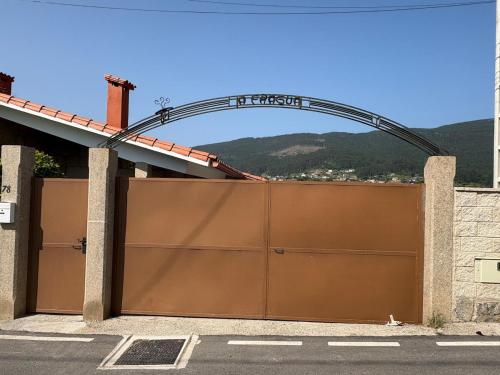 a garage with a large brown garage door at A Fragua de Nicanor in Vilaboa