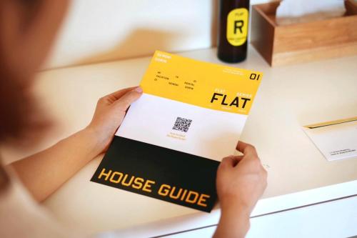 a person is holding a book on a table at Sendai FLAT 01 GORIN in Sendai