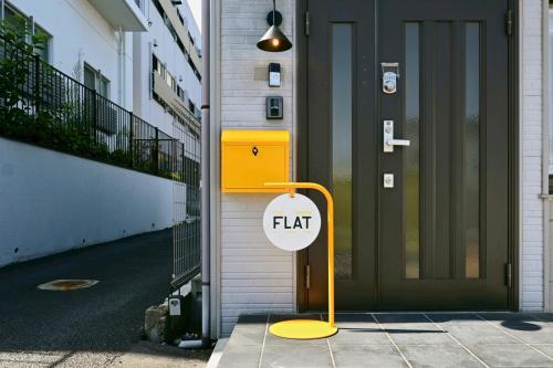 a sign that says flat next to a door at Sendai FLAT 01 GORIN in Sendai
