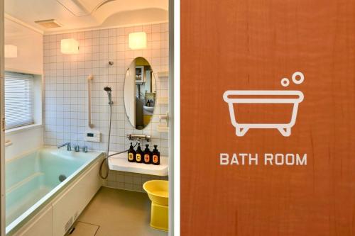 a bathroom with a bath room with a bath tub and a bathroom with a bath at Sendai FLAT 01 GORIN in Sendai